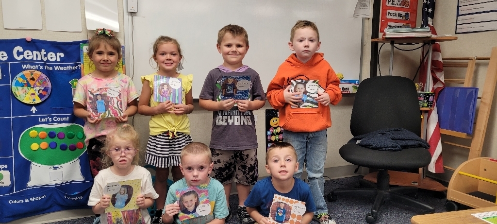 The kindergarten students holding up their cards.